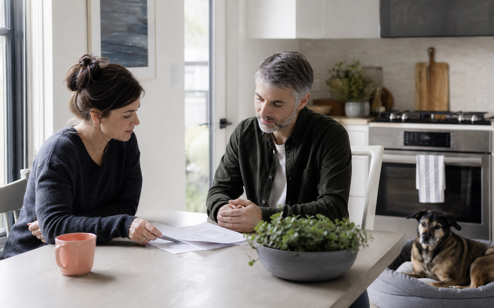 Pet owner and sitter reviewing care notes together at home